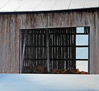 painting of the side of an weather barn with the barn door open. You can see inside and through to the other side